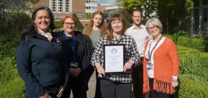 Pictured with the award (from left) Mitie General Manager, Waste and Environmental Services Isobel McGlashon; head of Campus Operations Michelle Dene, Waste & Recyling Officer Fiona Wheatley, Mitie sustainability student Devyn Simeoni, head of Sustainability Teifion Maddocks and Mitie Site Manager Christine Winstone. Credit: Swansea University