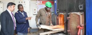 From left, Aga Khan University Hospital Chief Executive Officer Rashid Khalani is joined by Engineer Dennis Mwangi as he inspects the recently commissioned Biomass Boiler